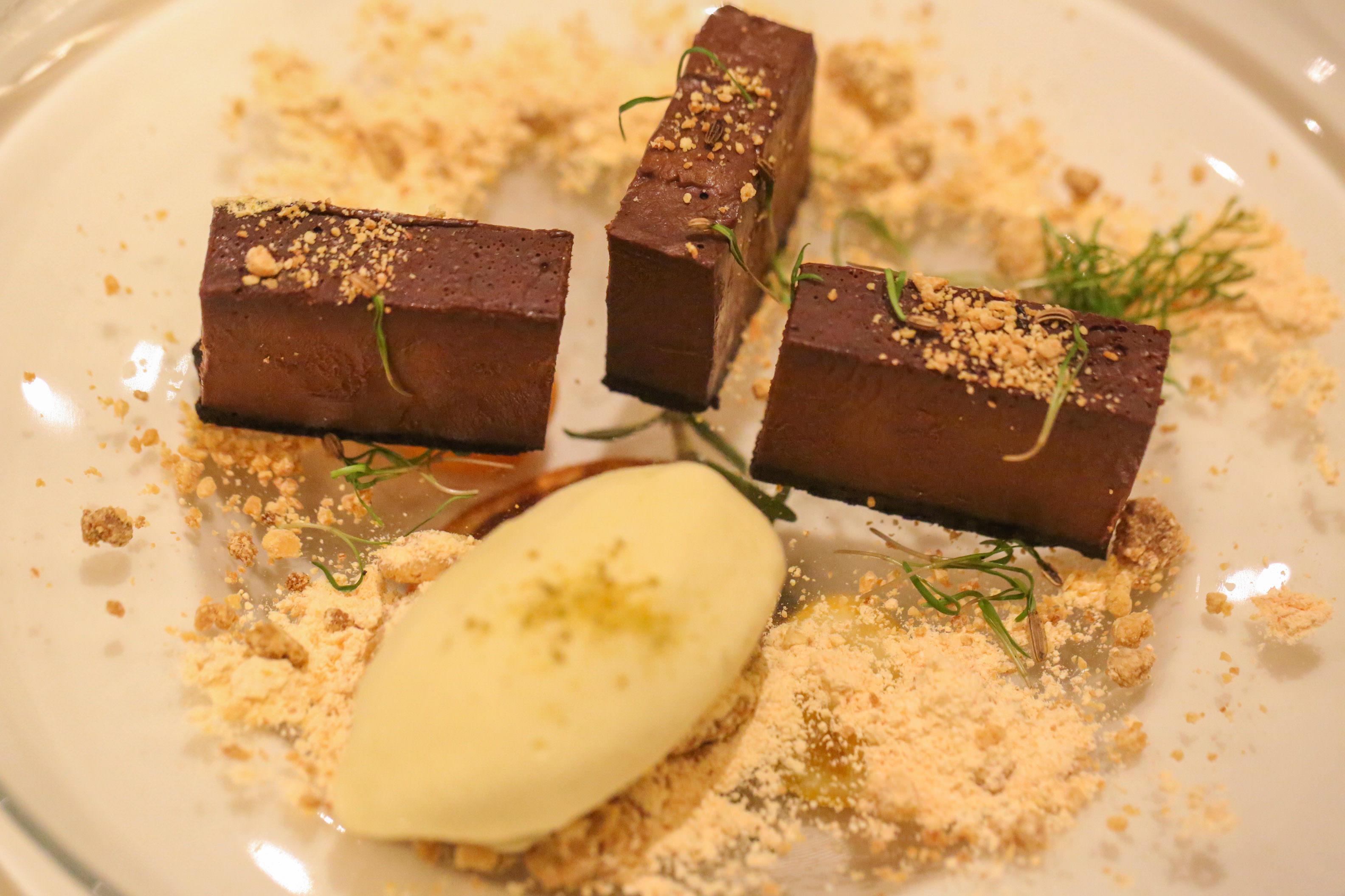 Dark Chocolate & Rosemary Tart with Fennel Ice-Cream, Orange Sherbet & Baked White Chocolate