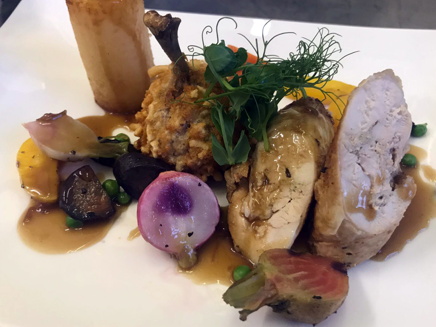 Dine Events Catering | Boned Rolled Poussin accompanied with popcorn chicken leg with a smoked garlic & thyme mouselline, tall fondant potato, rustic three shade carrots, radish, peas, candied beetroot & turnip